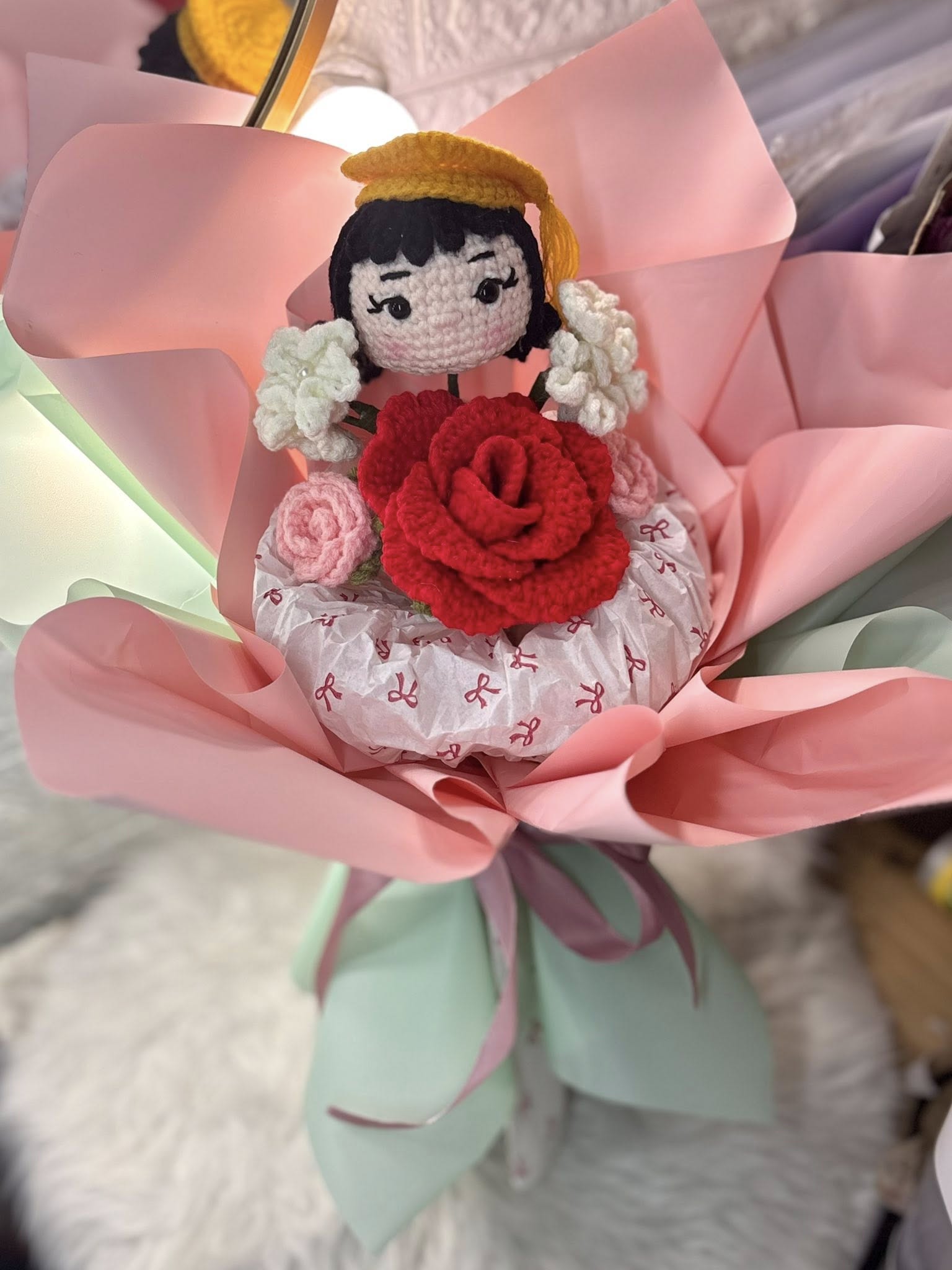 A doll cradling a hand-stitched rose